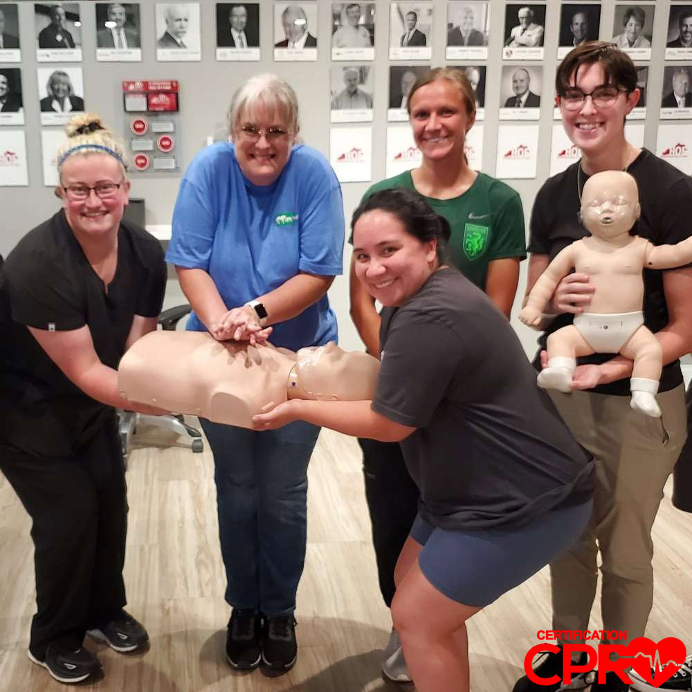 CPR training class in Nashville with students practicing on mannequins.