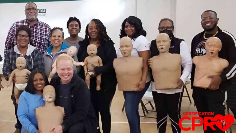 Group CPR training session in Nashville with mannequins for certification.