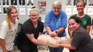 Group CPR training session in Nashville with instructor and students.