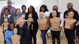 Group CPR training session with mannequins in Nashville.